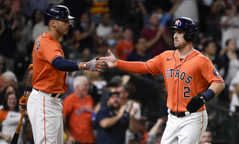 Houston Astros' Alex Bregman, right, celebrates with with Carlos Correa after scoring a run on Yordan Alvarez's RBI-double during the third inning of a baseball game against the Los Angeles Angels, Friday, Sept. 10, 2021, in Houston. (AP Photo/Eric Christian Smith)