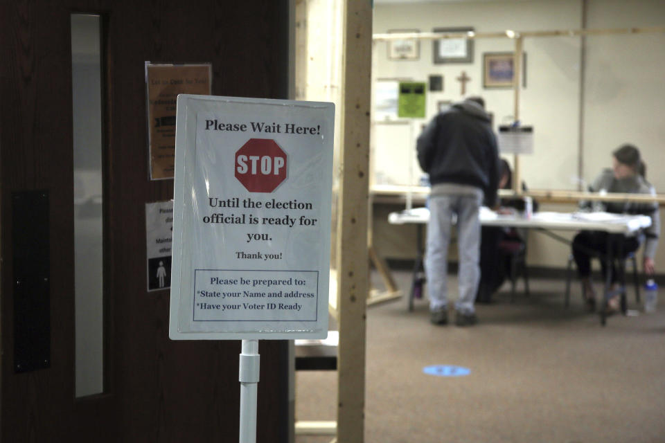 A sign alert voters at the United Methodist Church polling place Tuesday, May 12, 2020, in Hudson, Wis.in Wisconsin's special congressional election to replace retired Republican reality TV star Sean Duffy, in the 7th District race between Republican Tom Tiffany and Democrat Tricia Zunker. (AP Photo/Jim Mone)