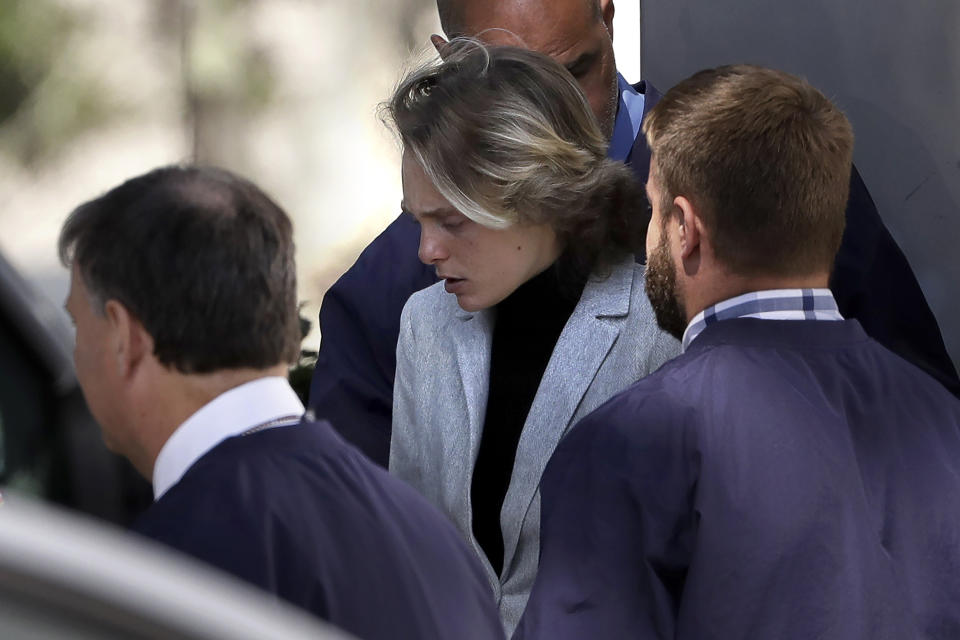 Michelle Carter, center, departs following a parole hearing on Thursday, Sept. 19, 2019 in Natick, Mass. Carter, who was sentenced to 15 months in jail for urging her suicidal boyfriend via text messages to take his own life, is asking for early release. (AP Photo/Steven Senne)