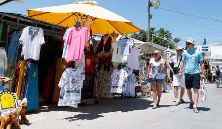 Tourists walk past souvenir shops in Sidi Bou Said, an attractive tourist destination near Tunis, Tunisia July 18, 2017. REUTERS/Zoubeir Souissi