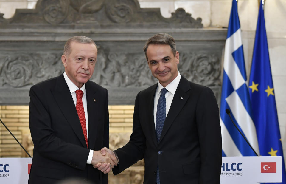 Greece's Prime Minister Kyriakos Mitsotakis, right, shakes hands with Turkey's President Recep Tayyip Erdogan after their statements at Maximos Mansion in Athens, Greece, Thursday, Dec. 7, 2023. Turkish President Recep Tayyip Erdogan is visiting Greece in an effort to mend strained relations and reset ties with Western allies. (AP Photo/Michael Varaklas)