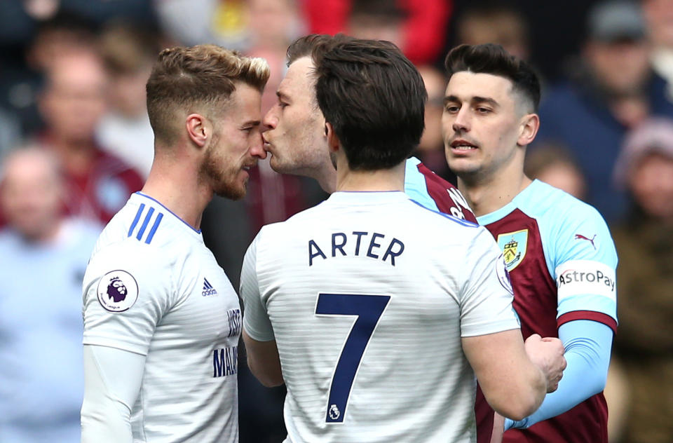 BURNLEY, ENGLAND - APRIL 13: Ashley Barnes of Burnley kisses Joe Bennett of Cardiff City as they clash during the Premier League match between Burnley FC and Cardiff City at Turf Moor on April 13, 2019 in Burnley, United Kingdom. (Photo by Jan Kruger/Getty Images)