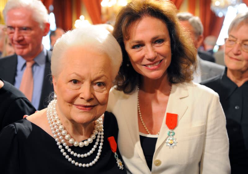 Actresses Bisset and de Havilland pose together after they were awarded with the Legion d'honneur in Paris