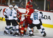 Calgary Flames' Milan Lucic, center, celebrates his goal as San Jose Sharks players crowd the net during the second period of an NHL hockey game, Tuesday, Nov. 9, 2021 in Calgary, Alberta. (Jeff McIntosh/The Canadian Press via AP)