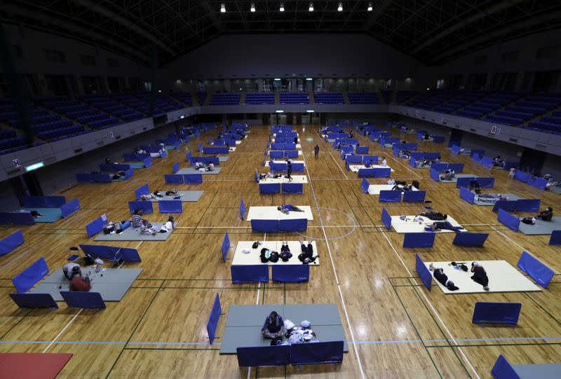 Local residents practice social distancing in the evacuation centre for the affected by the flooded area caused by heavy rain along Kuma River in Hitoyoshi