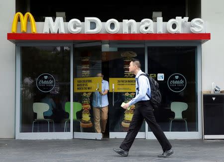 A man passes a McDonald's restaurant in Singapore July 25, 2016. Picture taken July 25, 2016. REUTERS/Edgar Su