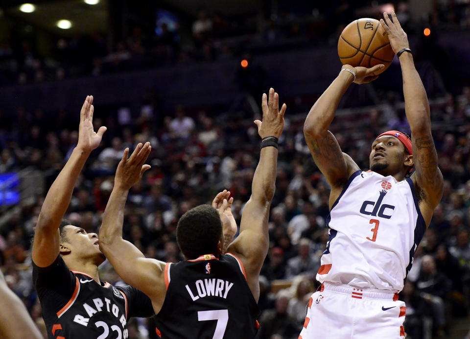 Washington Wizards guard Bradley Beal (3) makes the shot as Toronto Raptors guard Fred VanVleet (23) and teammate Kyle Lowry (7) defend during the second half of an NBA basketball game Friday, Dec. 20, 2019, in Toronto. (Frank Gunn/The Canadian Press via AP)