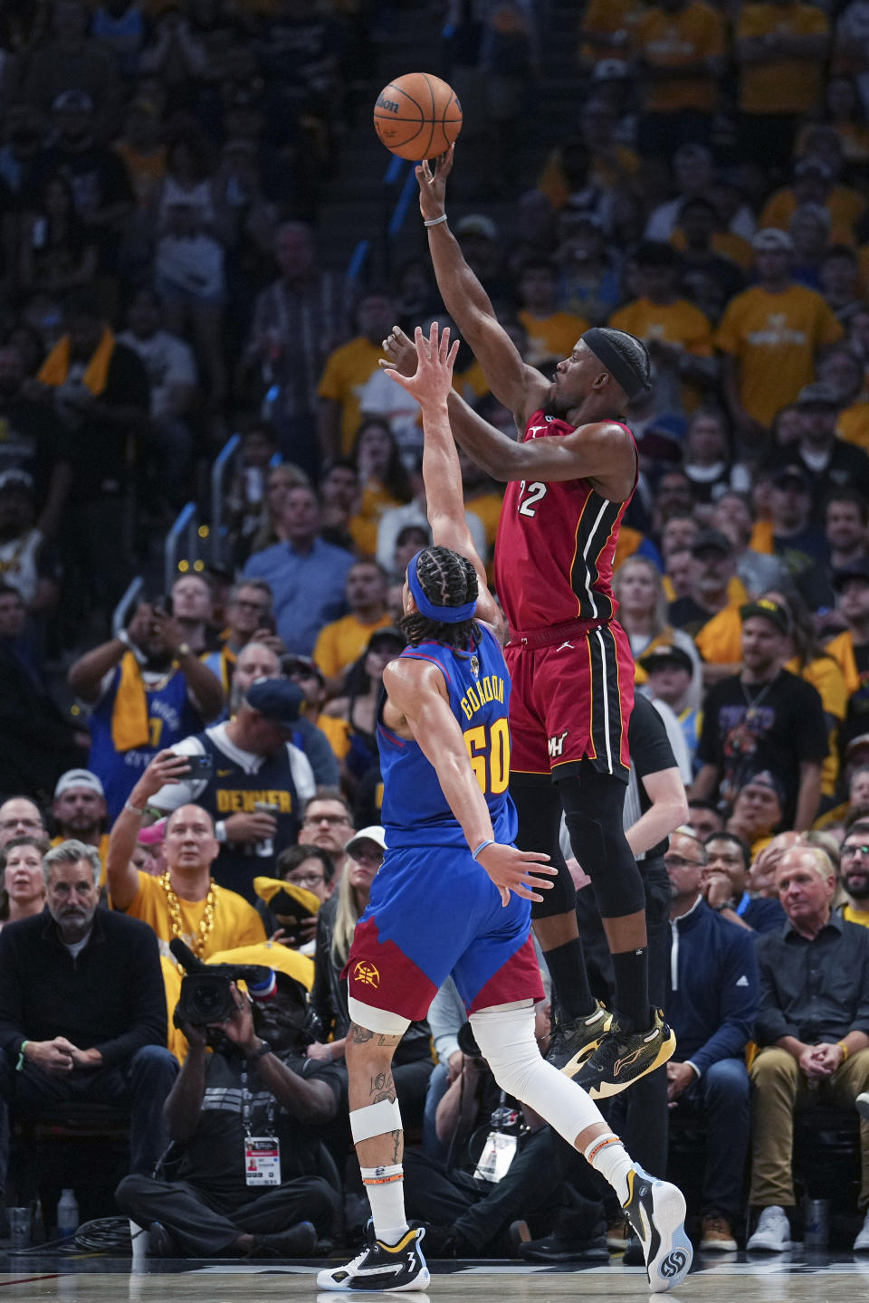 Miami Heat forward Jimmy Butler, right, shoots over Denver Nuggets forward Aaron Gordon during the first half of Game 1 of basketball's NBA Finals, Thursday, June 1, 2023, in Denver. (AP Photo/Jack Dempsey)