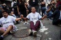 <p>Immigration activists protesting the Trump administration’s decision on the Deferred Action for Childhood Arrivals program sit in the street and block traffic on 5th Avenue near Trump Tower, September 5, 2017. (Photo: Drew Angerer/Getty Images) </p>