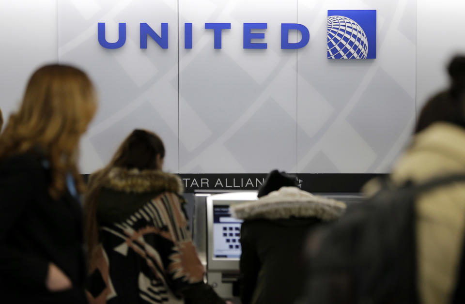 FILE- In this March 15, 2017, photo, people stand in line at a United Airlines counter at LaGuardia Airport in New York. A dog died on a United Airlines plane after a flight attendant ordered its owner to put the animal in the plane’s overhead bin. United said Tuesday, March 13, 2018, that it took full responsibility for the incident on the Monday night flight from Houston to New York. (AP Photo/Seth Wenig, File)