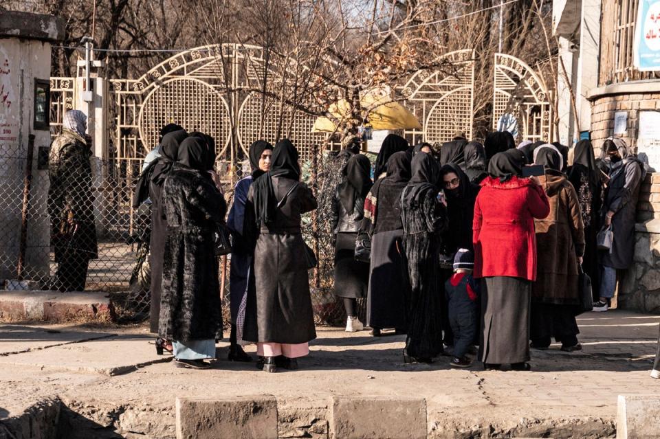 Students stopped by Taliban forces stand next to a university in Kabul on Wednesday (AFP/Getty)