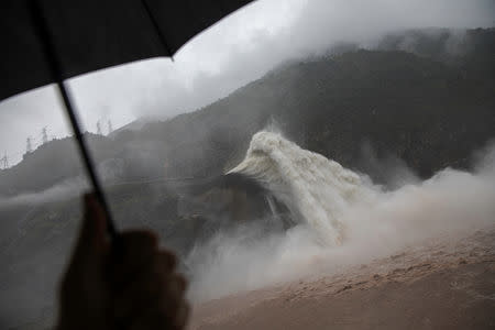 Water is released as heavy rain falls at a massive Pubugou Dam on the Dadu river, a tributary of the Yangtze River in Hanyuan County of Sichuan province, China, August 3, 2018. REUTERS/Damir Sagolj