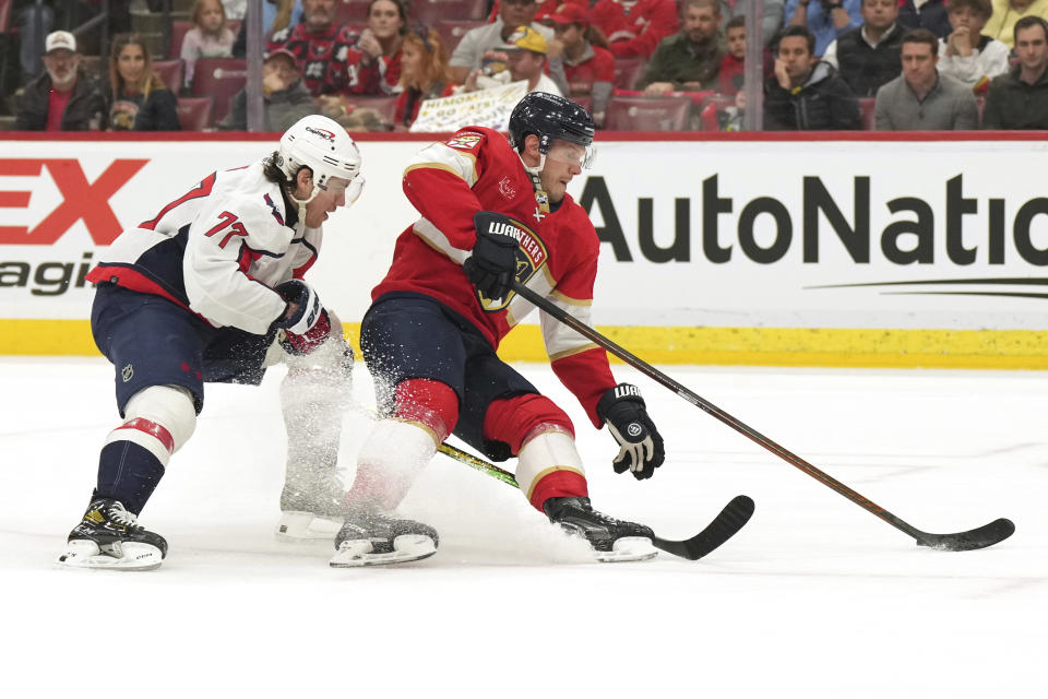 Washington Capitals right wing T.J. Oshie (77) is called for a tripping penalty against Florida Panthers defenseman Dmitry Kulikov, right, during the first period of an NHL hockey game Thursday, Feb. 8, 2024, in Sunrise, Fla. (AP Photo/Jim Rassol)