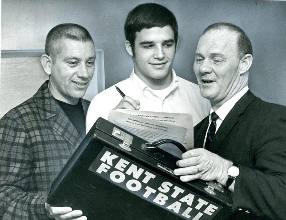 Gary Pinkel (center) signs to attend Kent State as Dick Fortner (left) and Tom Phillips look on.