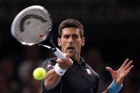 Novak Djokovic of Serbia hits a returns to Pierre-Hugues Herbert of France during their second round men's singles match at the Paris Masters tennis tournament at Bercy stadium in Paris, October 29, 2013. REUTERS/Charles Platiau