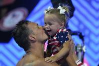 Ryan Lochte kisses his daughter after his heat in the men's 200 Individual Medley during wave 2 of the U.S. Olympic Swim Trials on Thursday, June 17, 2021, in Omaha, Neb. (AP Photo/Charlie Neibergall)