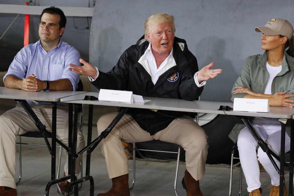 Trump sits between Puerto Rico Governor Ricardo Rossello and first lady Melania Trump as he receives a briefing on hurricane damage in Carolina, Puerto Rico, on Oct. 3. (Photo: Jonathan Ernst/Reuters)