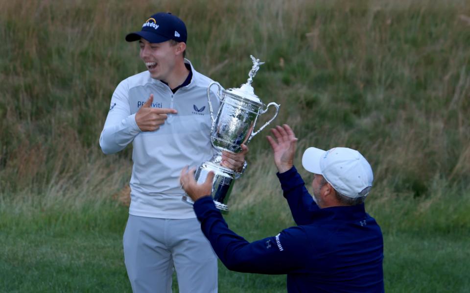    England's Matthew Fitzpatrick enjoys some photos with the trophy with his caddy Billy Foster - David Cannon/Getty Images