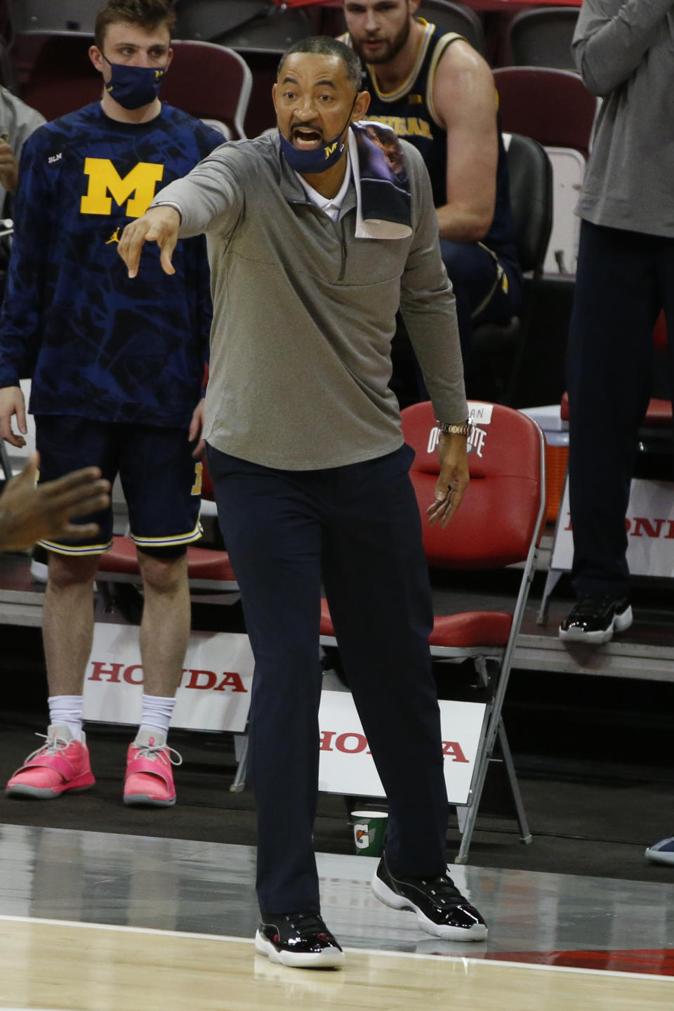 Michigan head coach Juwan Howard shouts to his team against Ohio State during the first half of an NCAA college basketball game Sunday, Feb. 21, 2021, in Columbus, Ohio. (AP Photo/Jay LaPrete)