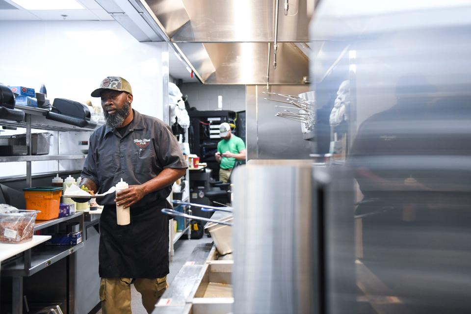 David Brent, kitchen manager at Main Street Pub, cooks menu items in the newly renovated kitchen in Spartanburg, S.C., on Wednesday, April 10, 2024.