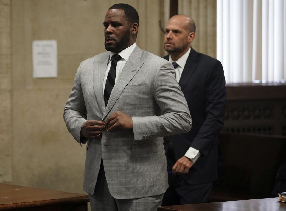 R. Kelly, left, stands in court before Judge Lawrence Flood at Leighton Criminal Court Building in Chicago on June 6, 2019.
