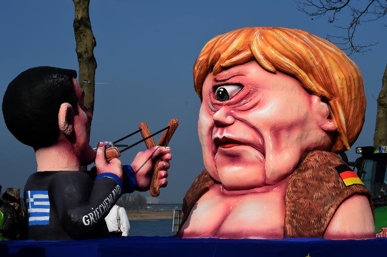 Figures depicting Greek Prime Minister Alexis Tsipras (L) and German Chancellor Angela Merkel in Duesseldor on February 16, 2015