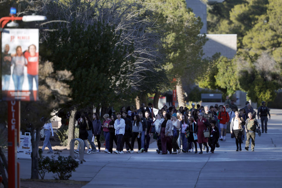 University of Nevada, Las Vegas, students, faculty and staff leave campus after sheltering-in-place following a fatal shooting on campus, Wednesday, Dec. 6, 2023, in Las Vegas. (Steve Marcus/Las Vegas Sun via AP)