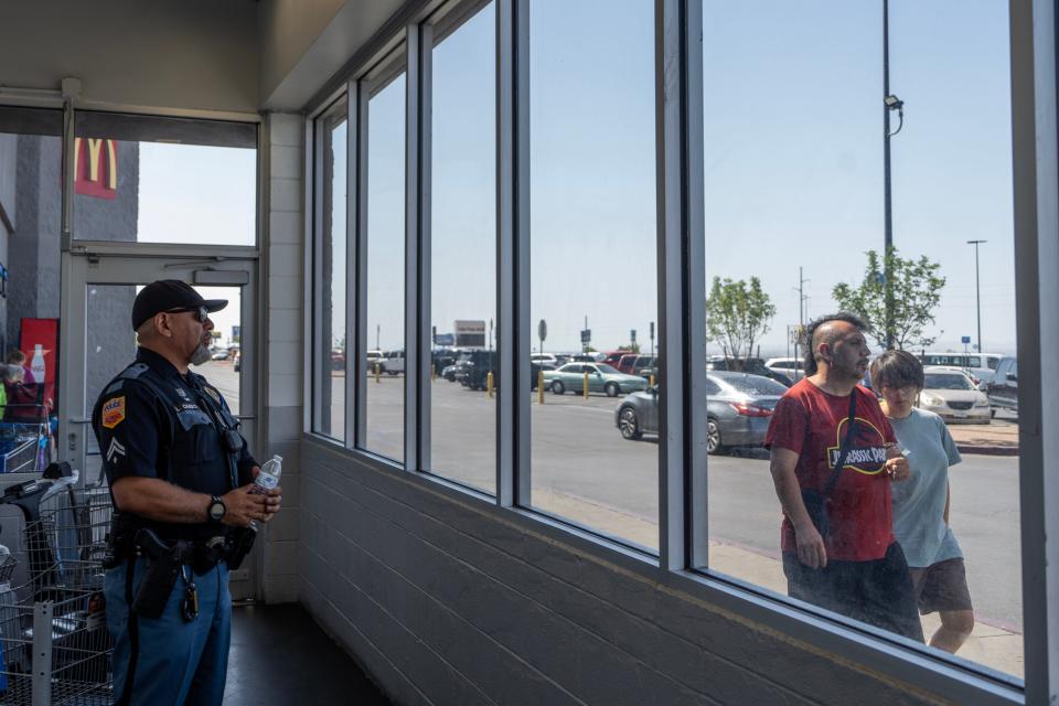 Officer Chagoya looks out over the Walmart parking lot on the fifth anniversary of the Aug. 3 Walmart shooting.  The officer did not give his first name.