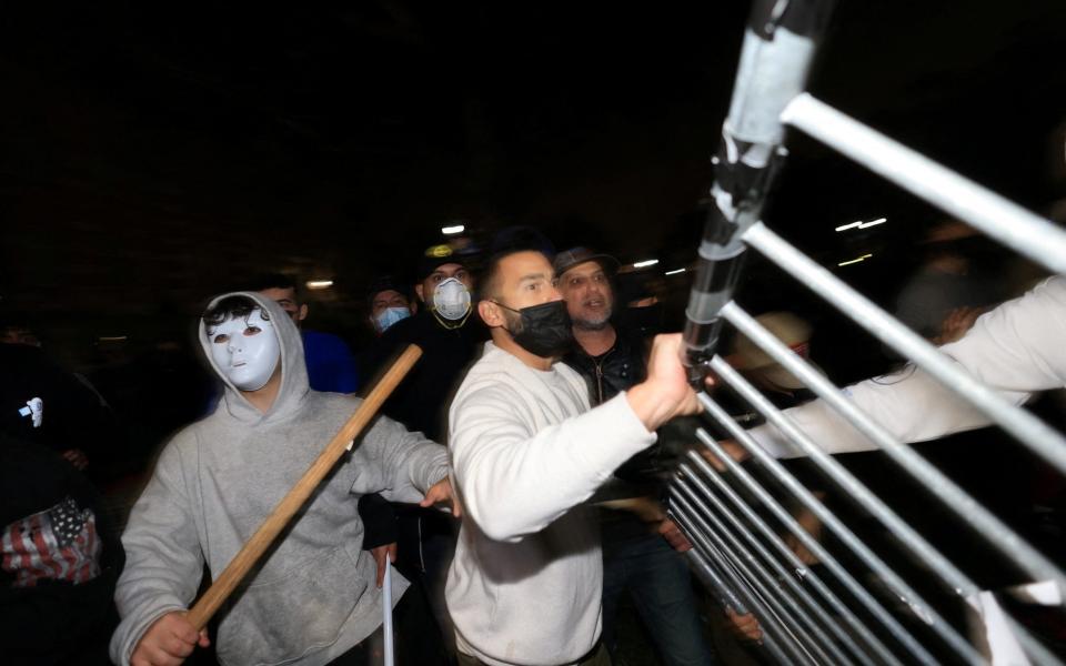 Counter-protesters try to remove barricades at a pro-Palestinian encampment on the University of California, Los Angeles (UCLA) campus