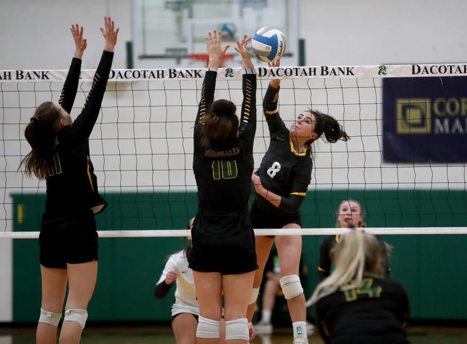 Faulkton Area outside hitter Isabel Aesoph sends the ball through Aberdeen Roncalli defenders during an October contest. Aesoph led the Trojans to the state tournament, where they placed fourth.