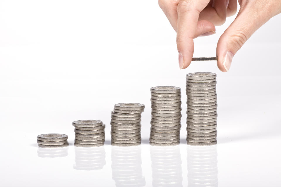 An image showing stacks of coins growing from left to right, to illustrate a story on Trust Bank increasing its base interest rate. 