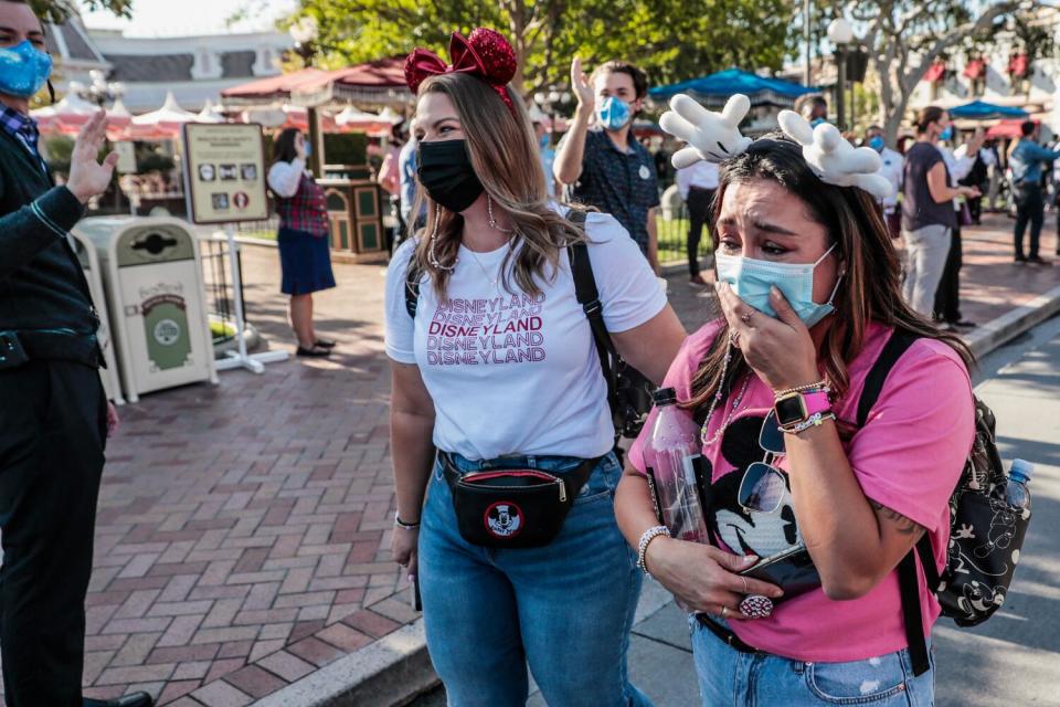 Two women, one crying, as they enter Disneyland.