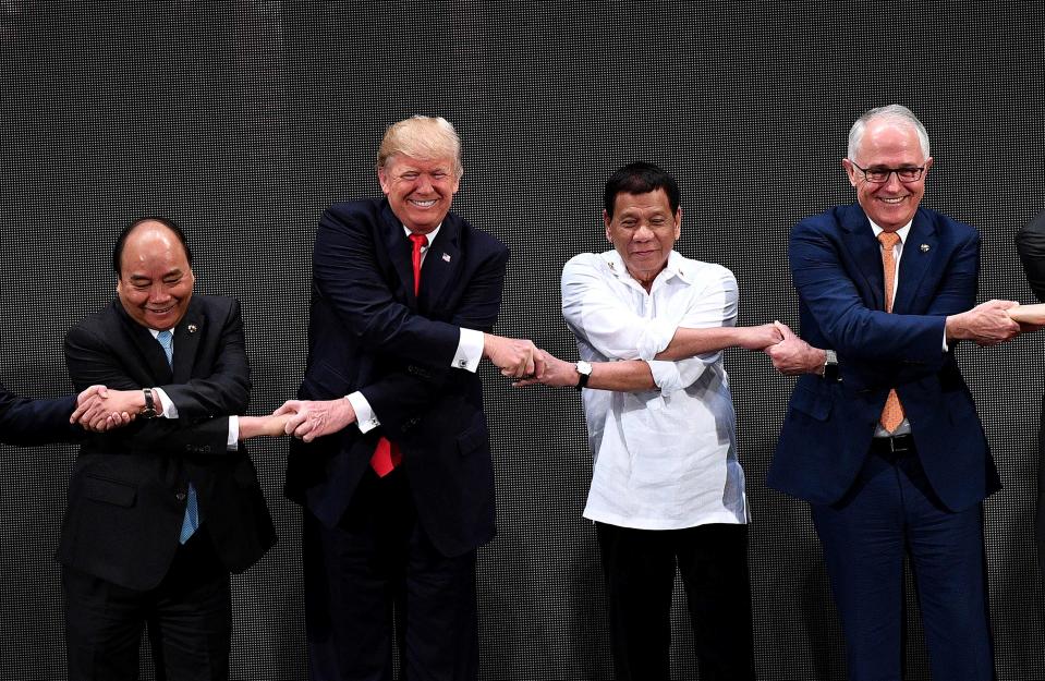 The Association of Southeast Asian Nations (ASEAN) members Vietnam's Prime Minister Nguyen Xuan Phuc, US President Donald Trump, Philippine President Rodrigo Duterte, Australia Prime Minister Malcolm Turnbull, link hands during the Opening ceremony of the 31st ASEAN Summit in Cultural Center of the Philippines (CCP) in Manila on November 13, 2017.