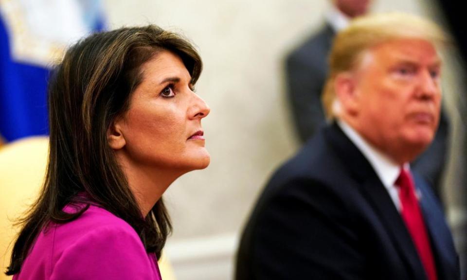 Nikki Haley sits next to the US president after announcing her resignation