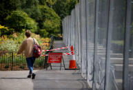 A pedestrian walks past a security fence surrounding the U.S. ambassador's residence, ahead of the U.S. presidential visit, in Regents Park, London, Britain July 11, 2018. REUTERS/Henry Nicholls