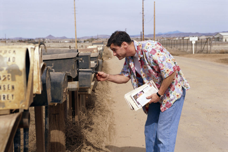 A man is checking the mailbox