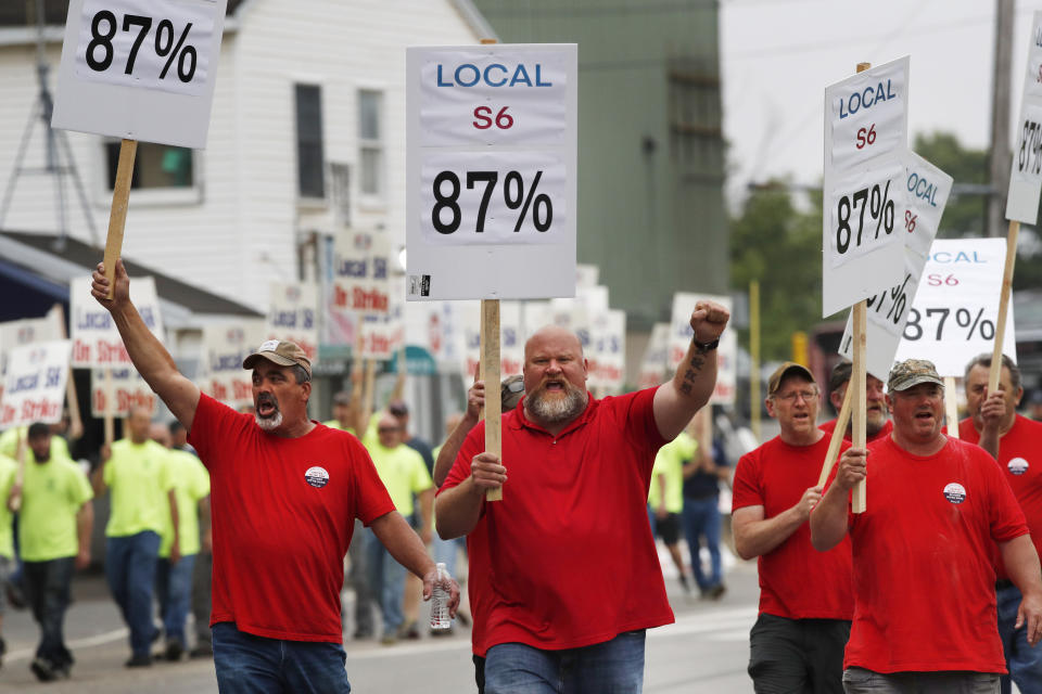 Union members picket outside Bath Iron Works, Monday, June 22, 2020, in Bath, Maine. Production workers at one of the Navy's largest shipbuilders overwhelmingly voted to strike, rejecting the company's three-year contract offer Sunday and threatening to further delay delivery of ships. (AP Photo/Robert F. Bukaty)