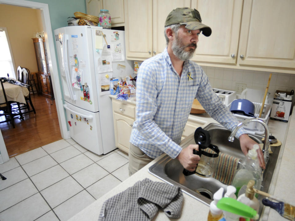 Alex Drueke makes a pot of coffee at home in Tuscaloosa, Ala., on Friday, Sept. 30, 2022. Drueke and fellow Alabamian Andy Huynh were captured earlier this year after traveling to Ukraine to help in the fight against Russian invaders. Both men were released from captivity recently. (AP Photo/Jay Reeves)