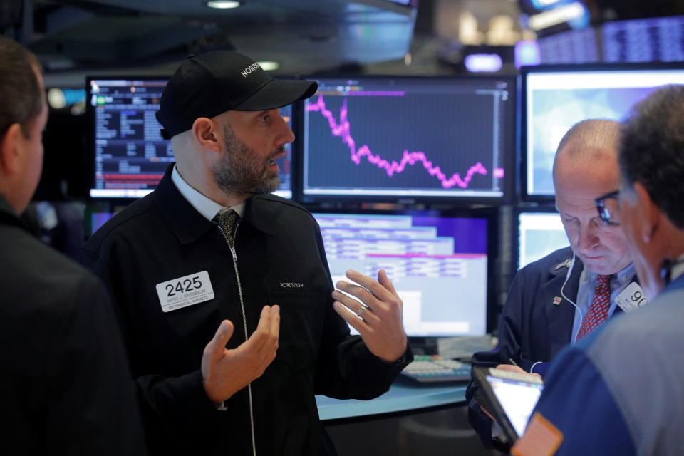 Traders work on the floor at the New York Stock Exchange (NYSE) in New York, U.S., October 22, 2019. REUTERS/Brendan McDermid