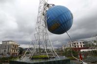 A man walks near a globe damaged by Typhoon Haiyan in Vietnam's northern Quang Ninh province, 112 miles away from Hanoi, November 11, 2013. (REUTERS/Kham)