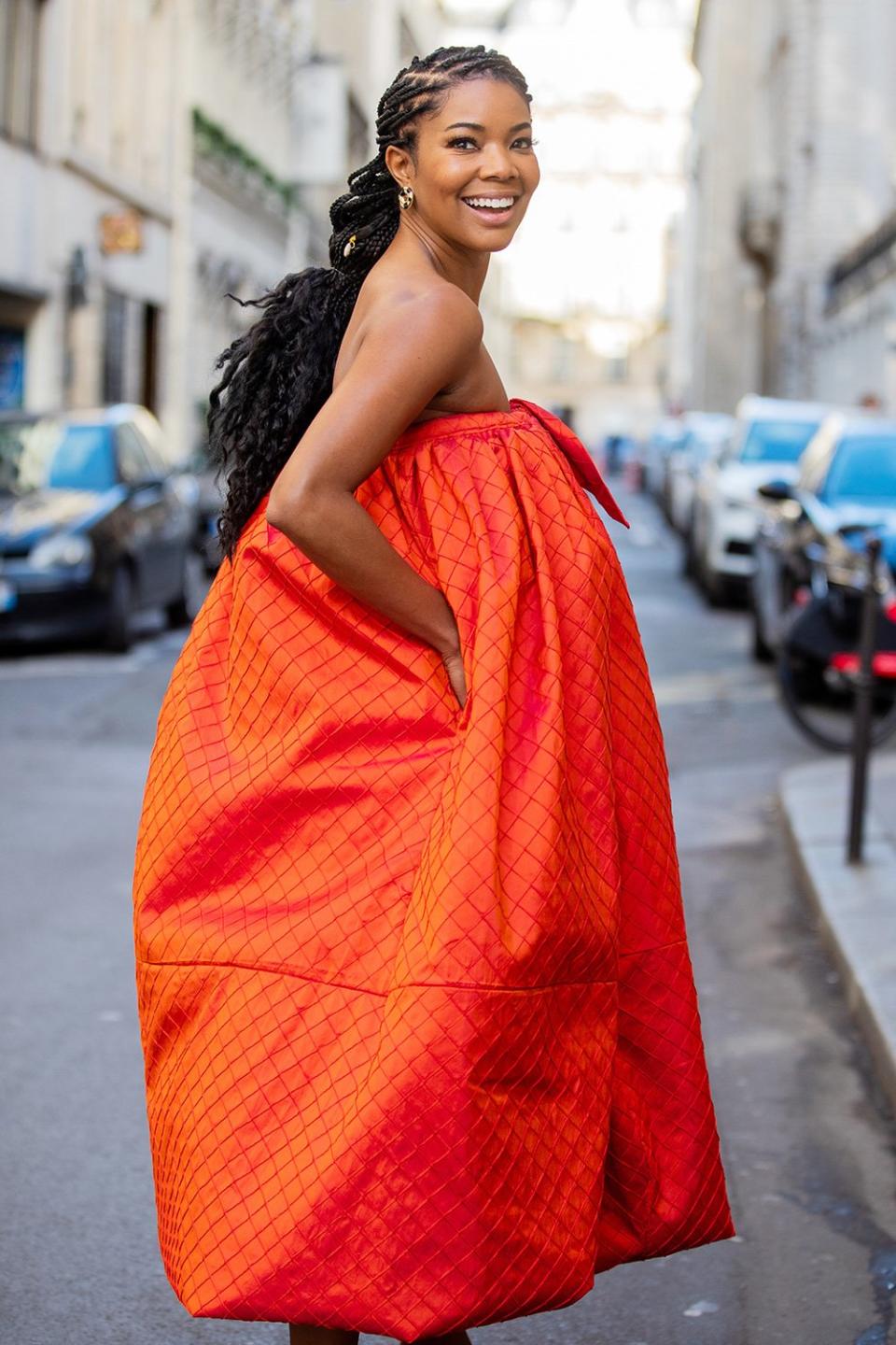 Gabrielle Union is seen rocking an orange, strapless Christopher John Rogers dress during Paris Fashion Week on Saturday.