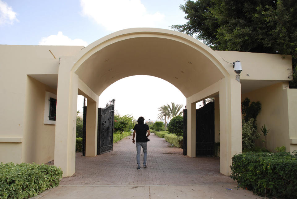 A man walks on the grounds of the U.S. consulate in Benghazi, Libya, after an attack that killed four Americans, including Ambassador Chris Stevens, Wednesday, Sept. 12, 2012. (AP Photo/Ibrahim Alaguri)