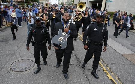 Rodd Bland, son of Bobby "Blue" Bland, carries the iconic Gibson guitar named "Lucille" belonging to the late B.B. King during a procession down Beale Street in Memphis, Tennessee May 27, 2015. REUTERS/Mike Blake