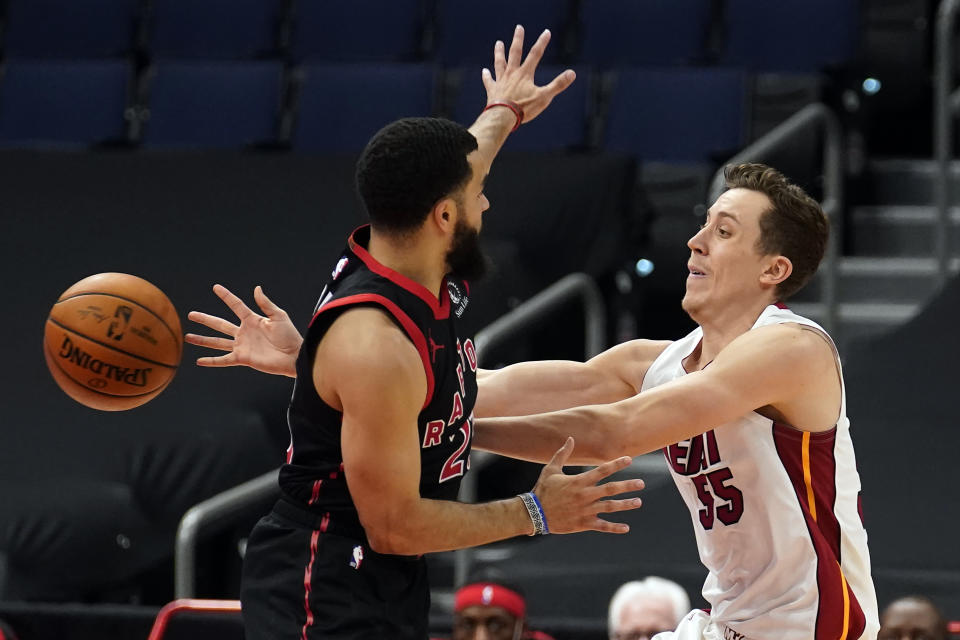 Miami Heat guard Duncan Robinson (55) passes the ball around Toronto Raptors guard Fred VanVleet (23) during the second half of an NBA basketball game Friday, Jan. 22, 2021, in Tampa, Fla. (AP Photo/Chris O'Meara)