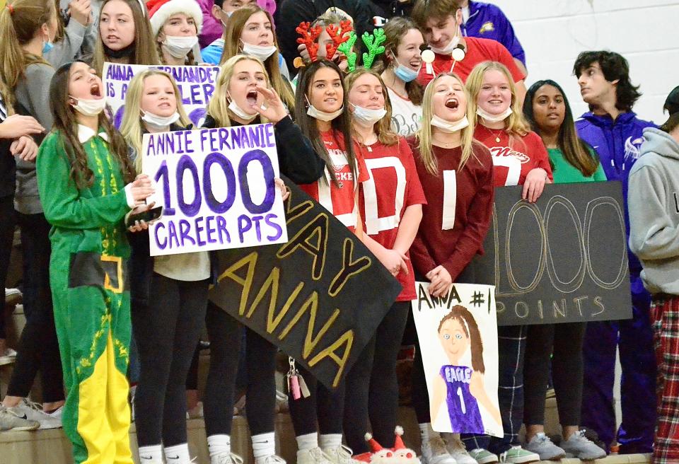 Plymouth Christian's student section waves signs celebrating Anna Fernandez, who recently scored 1,000 career points, during a girls basketball game against Ypsilanti Arbor Prep on Friday, Dec. 17, 2021.