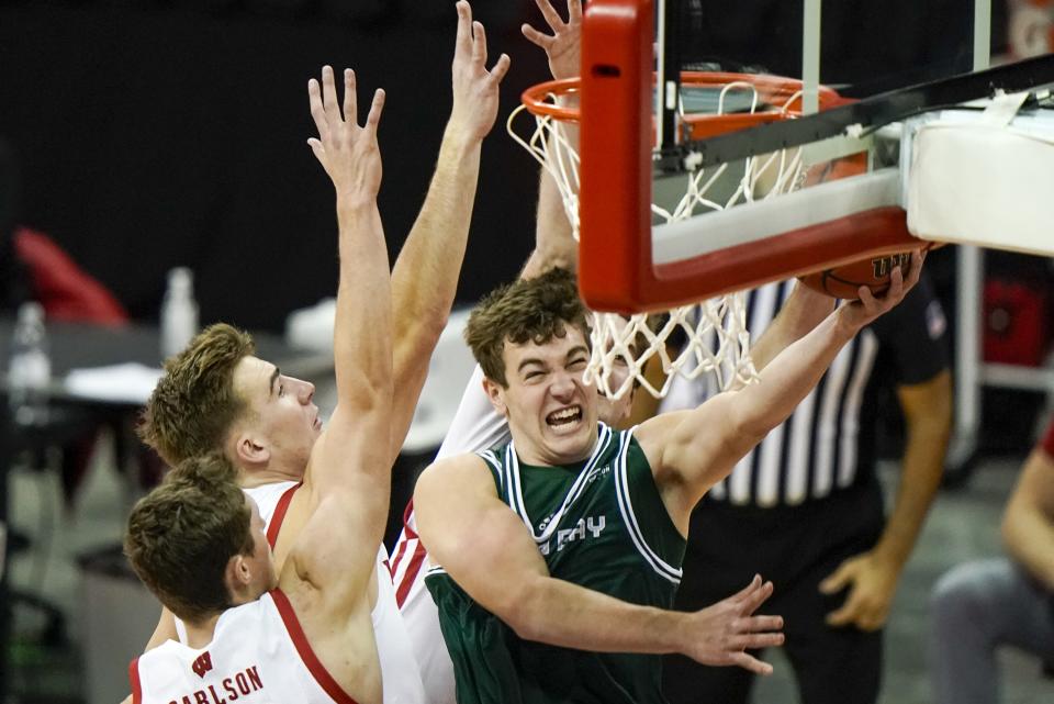 Wisconsin-Green Bay's Lucas Stieber is fouled as he shoots during the first half of an NCAA college basketball game against Wisconsin Tuesday, Dec. 1, 2020, in Madison, Wis. (AP Photo/Morry Gash)