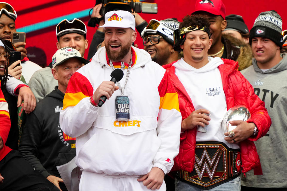 KANSAS CITY, MISSOURI - FEBRUARY 15: Travis Kelce #87 and Patrick Mahomes #15 of the Kansas City Chiefs celebrate on stage during the Kansas City Chiefs Super Bowl LVII victory parade on February 15, 2023 in Kansas City, Missouri. (Photo by Jay Biggerstaff/Getty Images)