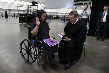 Tatev, who is from Armenia and has lived in the U.S. for 17 years and Judge Cormac J. Carney are seen during a quick impromptu naturalization ceremony before the official event in Los Angeles