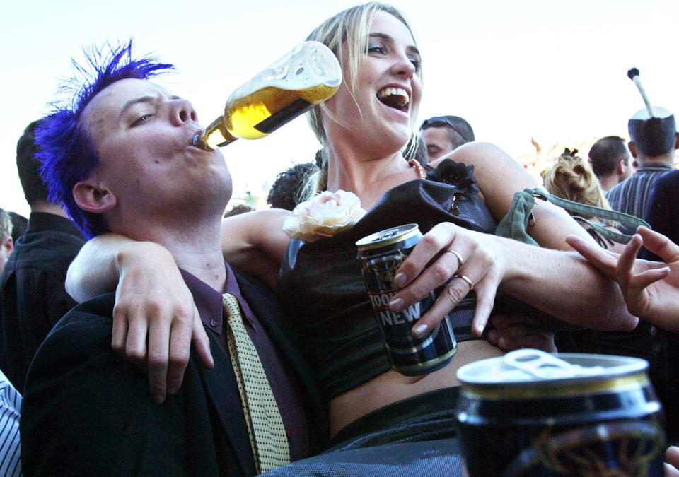 A couple, pictured here drinking beer after the Melbourne Cup in 2003. 