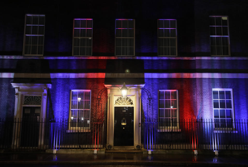 The colors of the British Union flag illuminate the exterior of 10 Downing street, the residence of the British Prime Minister, in London, England, Friday, Jan. 31, 2020. Britain officially leaves the European Union on Friday after a debilitating political period that has bitterly divided the nation since the 2016 Brexit referendum. (AP Photo/Kirsty Wigglesworth)